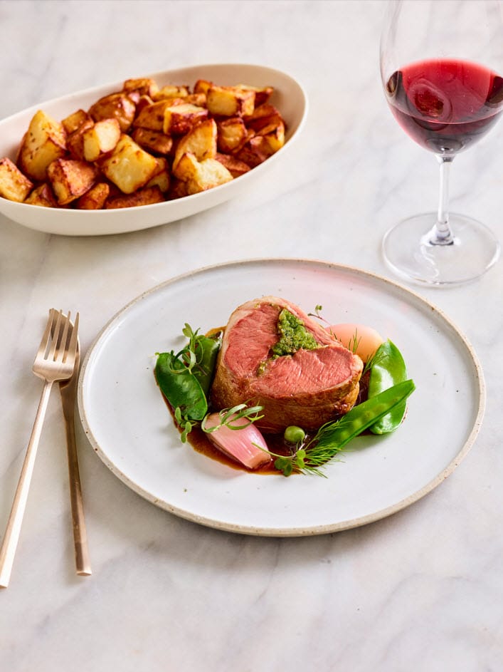 Saddle of lamb with Marsala and pepper jus and roasted potatoes