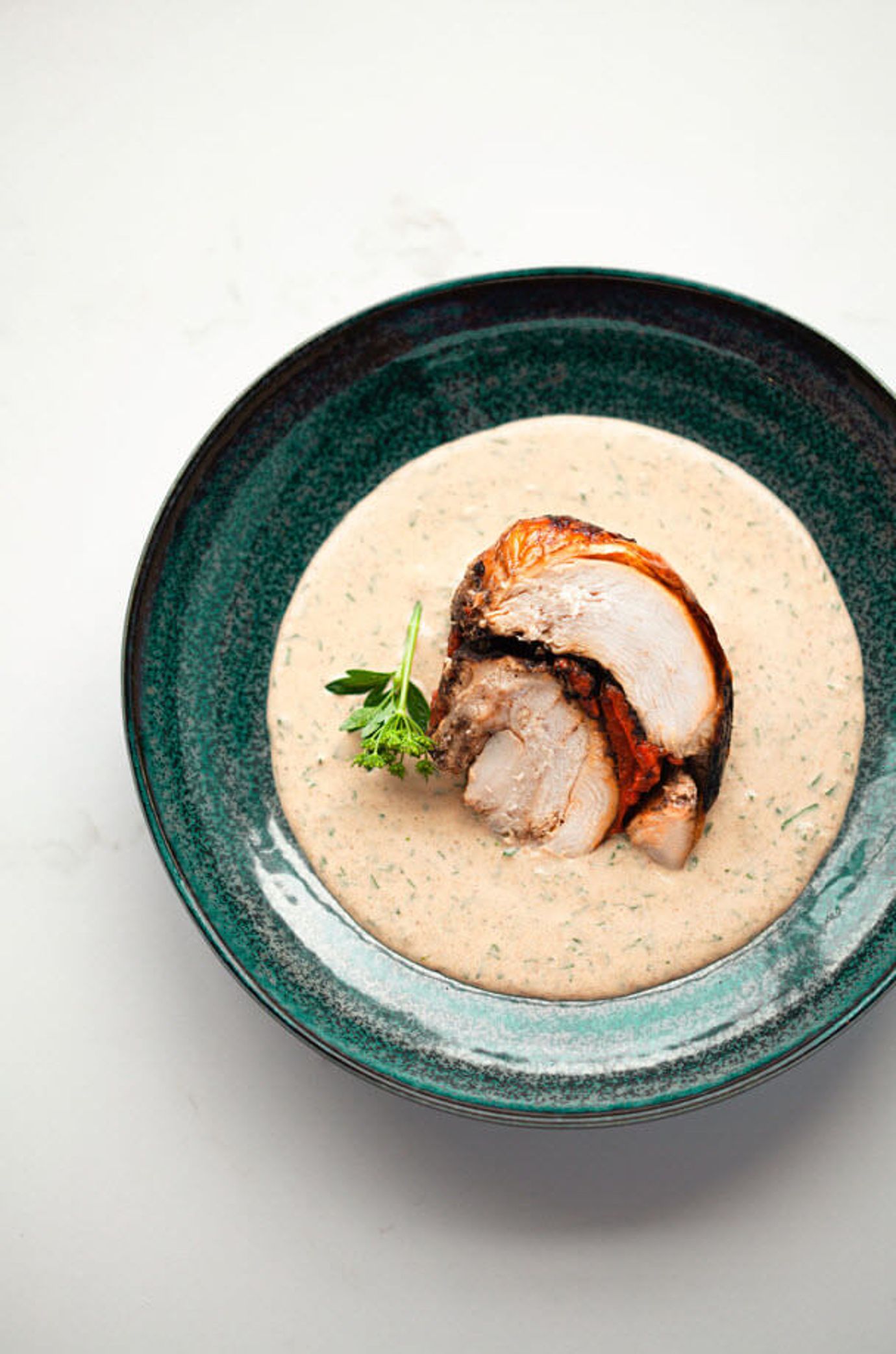 Turkey breast with red pepper, black garlic and almond sauce