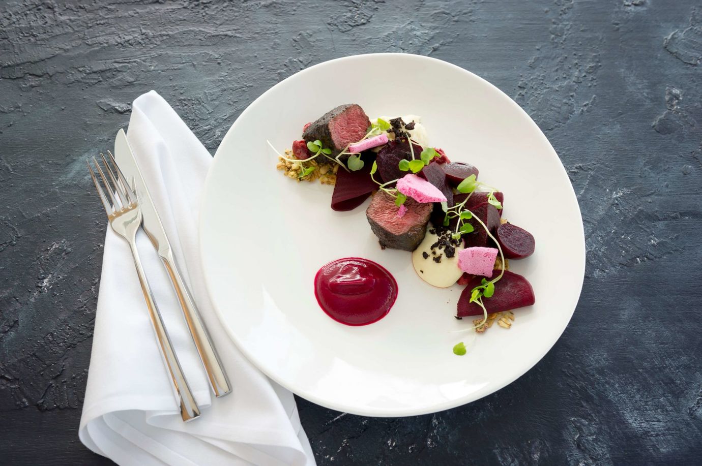 Ash-crusted Raukumara venison loin, beetroot textures, cherry granola, black pudding crumb, potato espuma