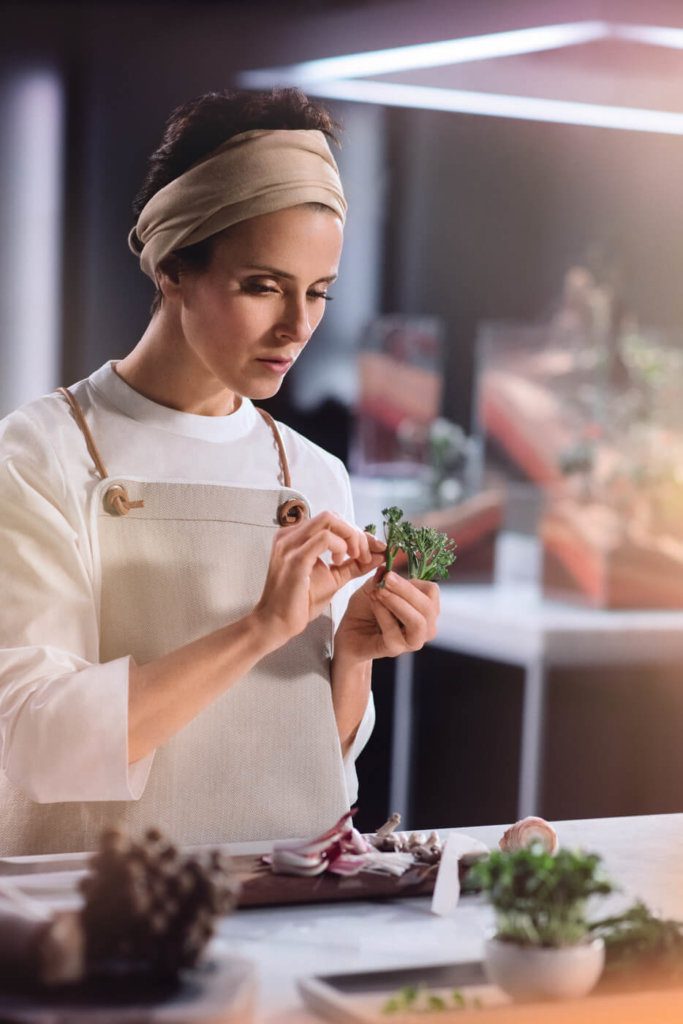 Chef stripping broccoli apart