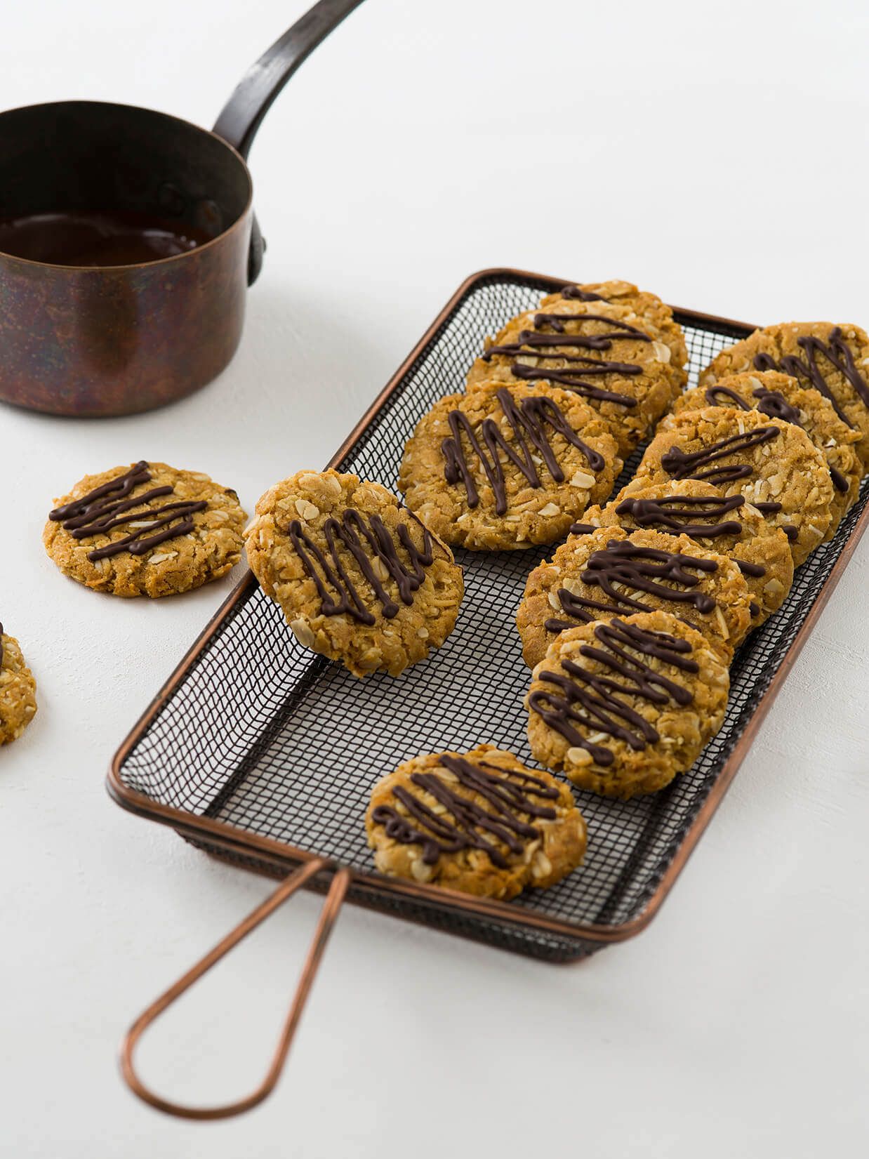 Chocolate drizzled golden syrup oat cookie