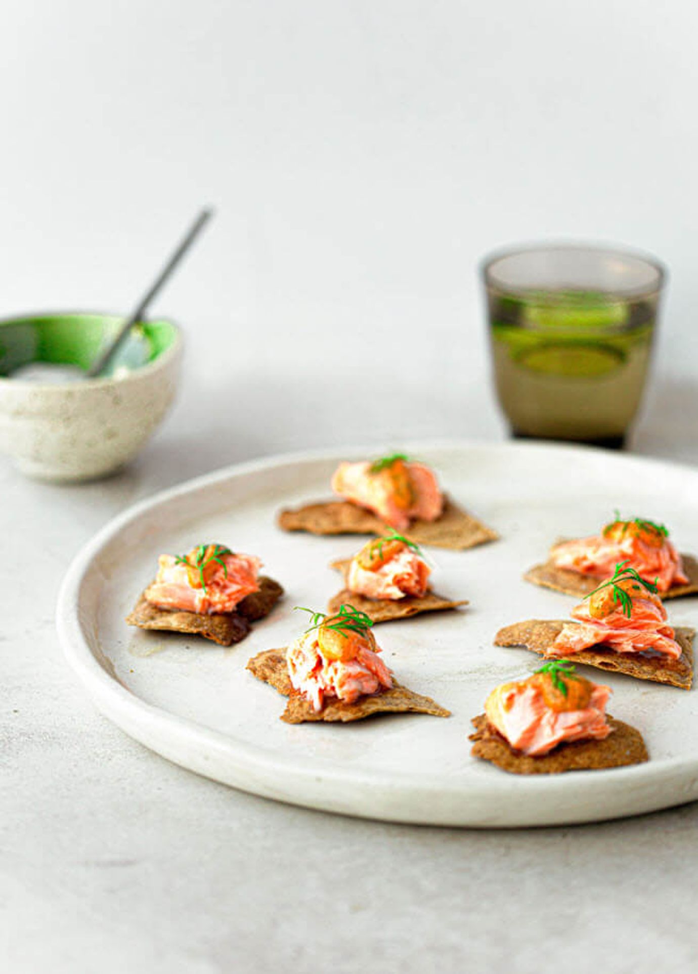 Salmon slow roasted on rye cracker with a tomato, dill butter sauce