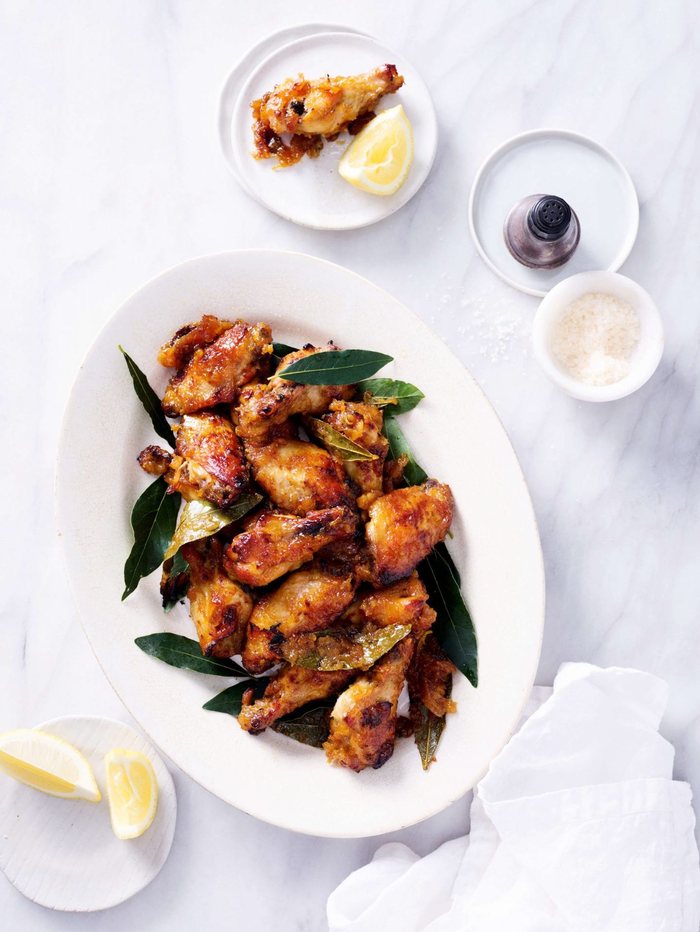 Baked chicken drumettes with mustard pears, lemon and bay leaf