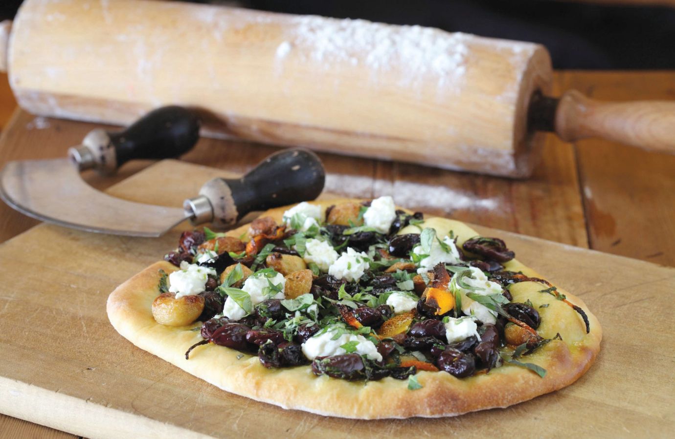 Olive, goat's cheese and orange pizza