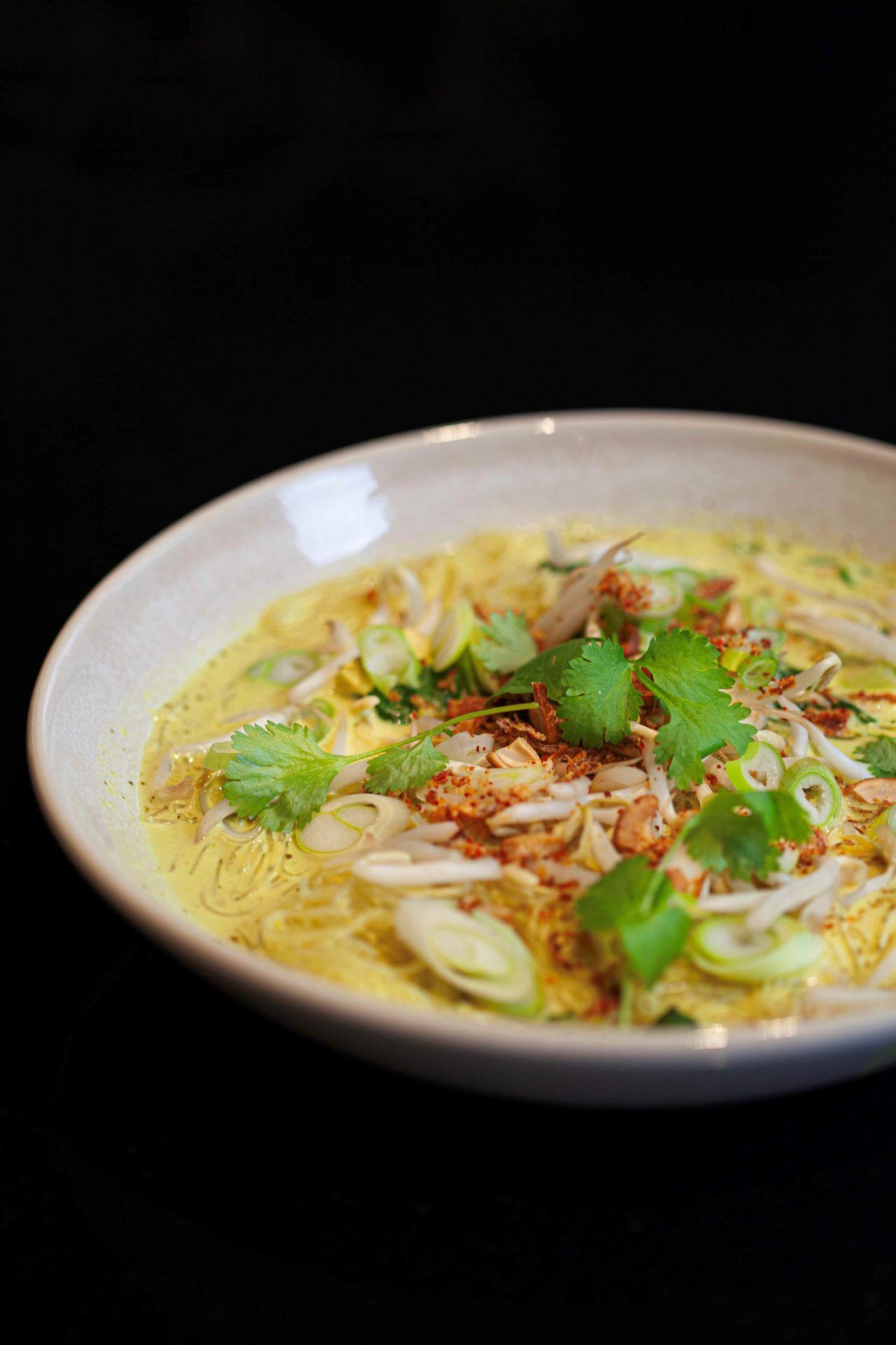 Laksa noodle soup with chilli cashew crumb