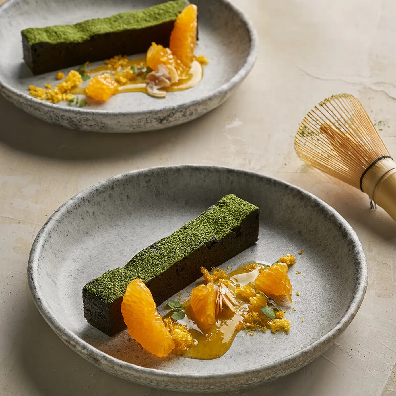 Matcha chocolate cake, salted almonds and mandarin sauce