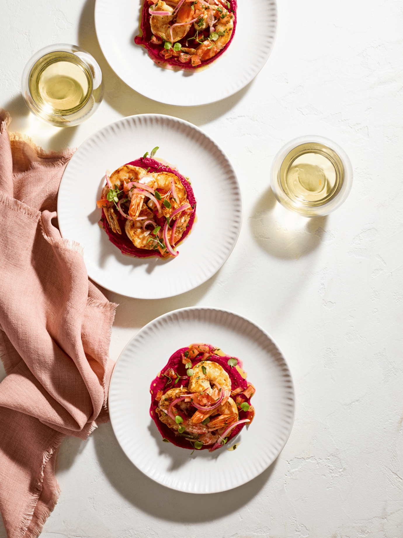 Grilled tiger prawns, pickled onion sauce vierge and beetroot hummus