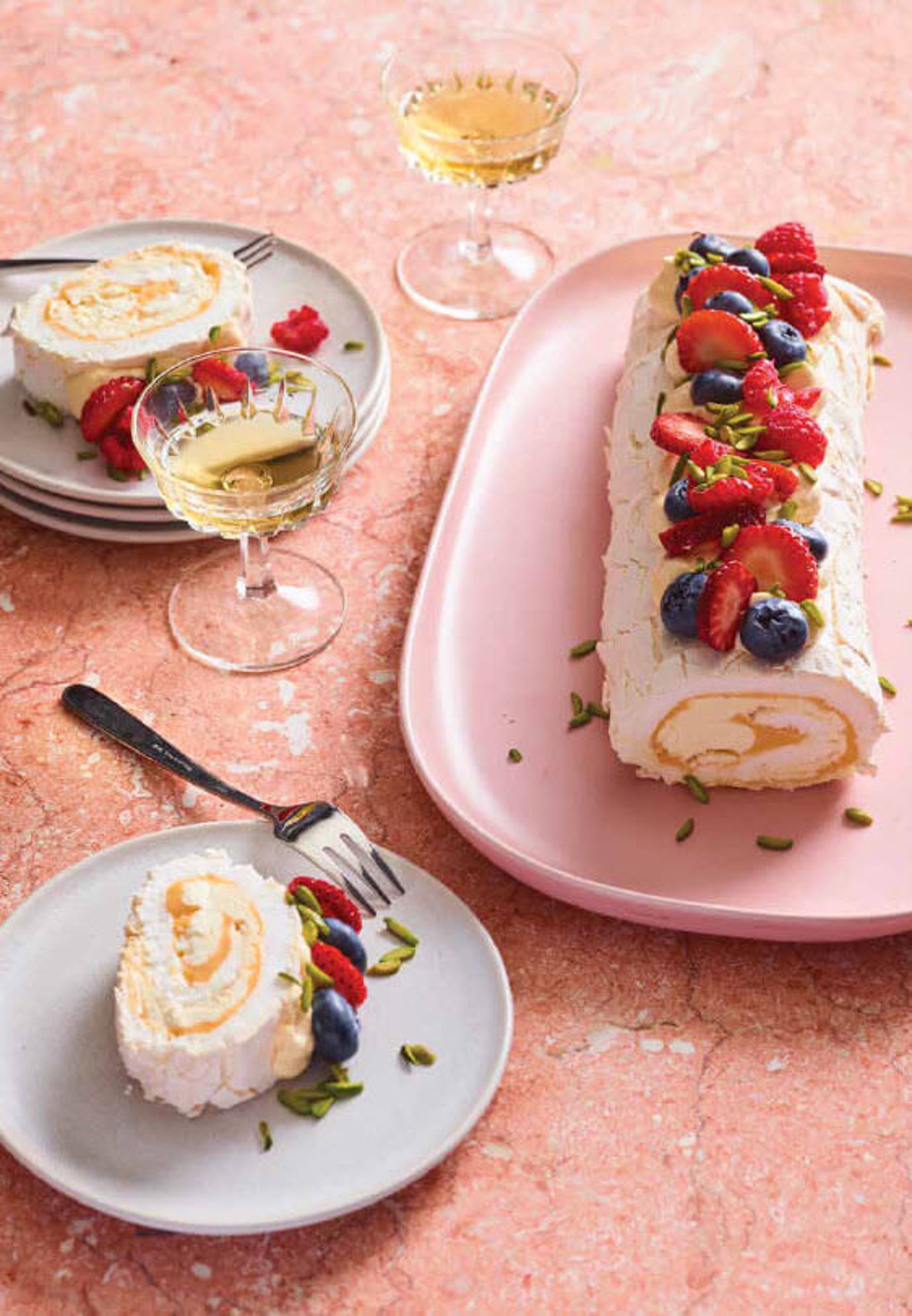 Meringue roulade with lemon curd and pistachios