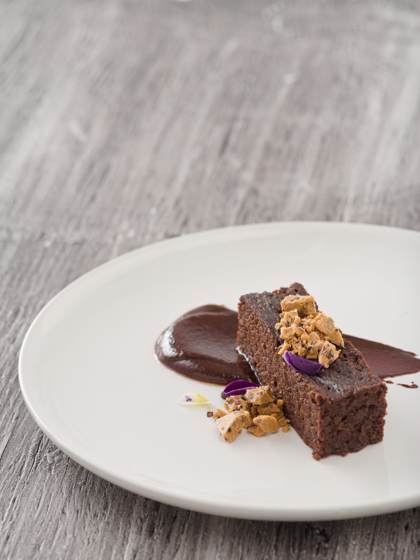 Flourless chocolate cake with ganache and cocoa nib crumble