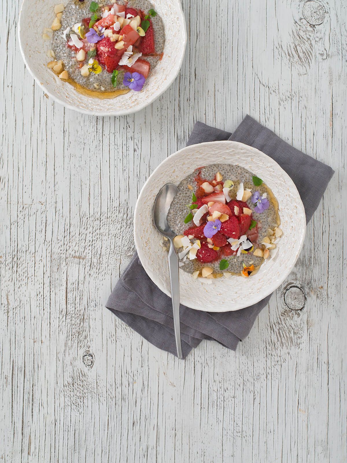 Coconut chia pudding with poached berries and macadamia