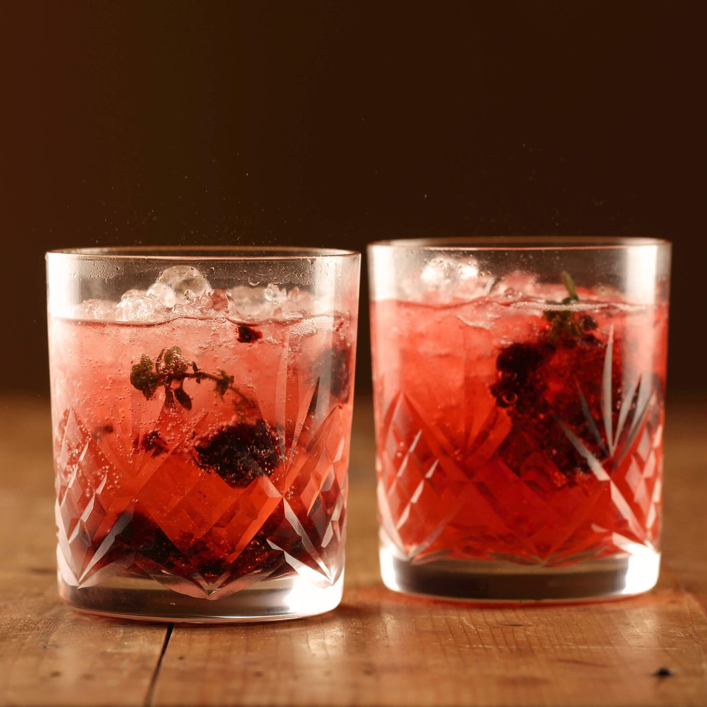Sparkling ruby cabernet mocktail with smashed blackberries and lemon thyme
