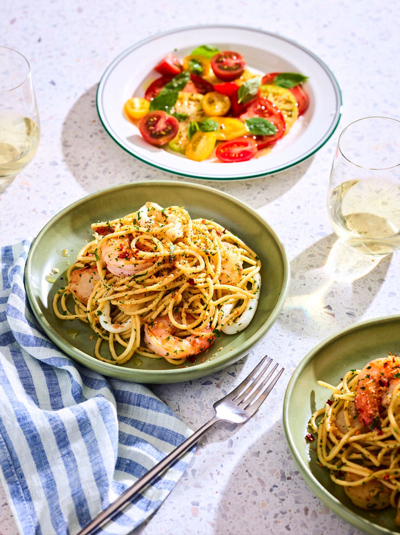 Spaghetti marinara with tomato salad and pangrattato