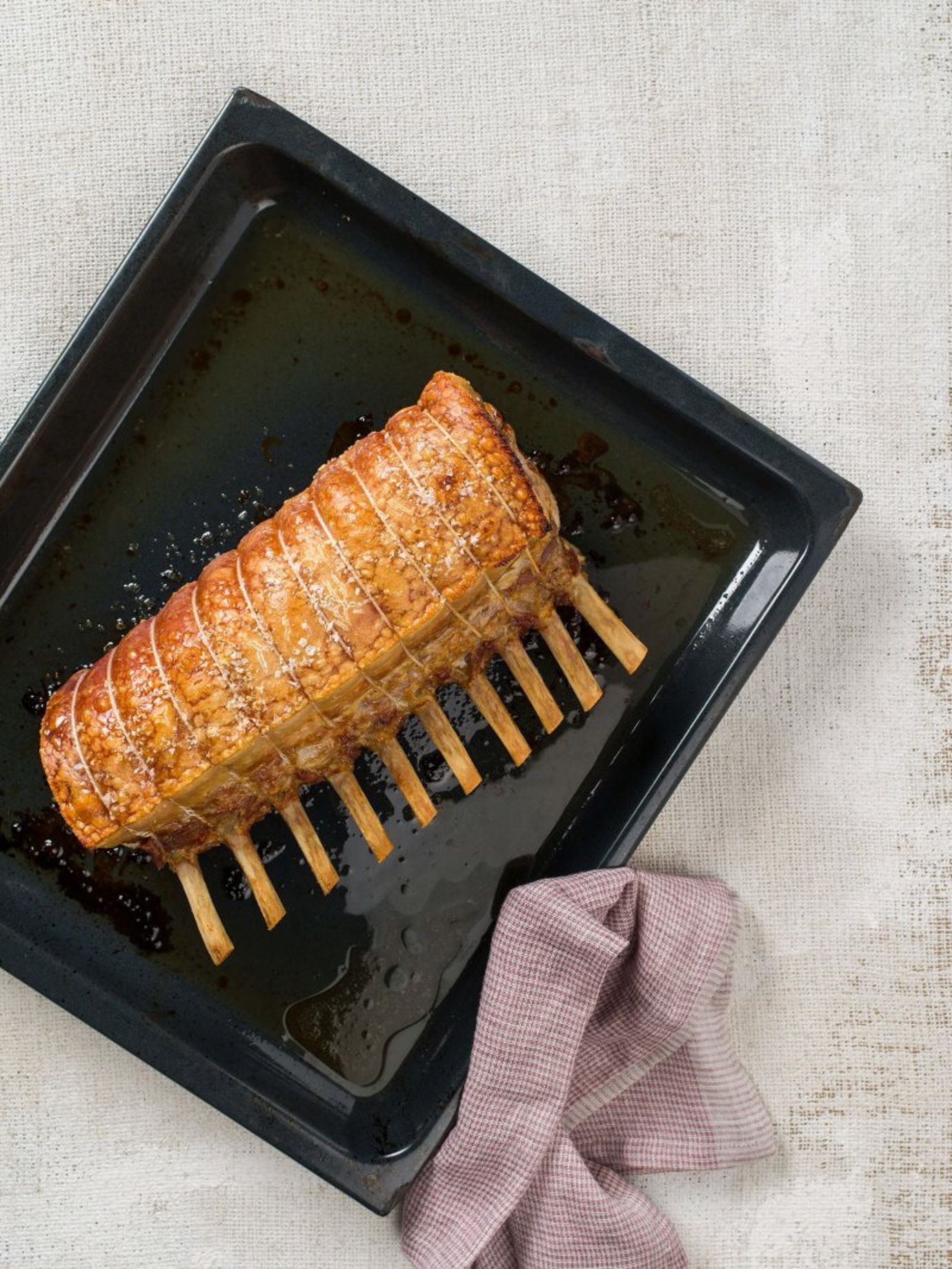 Roast pork rack with anchovy and caper butter and lentil salad