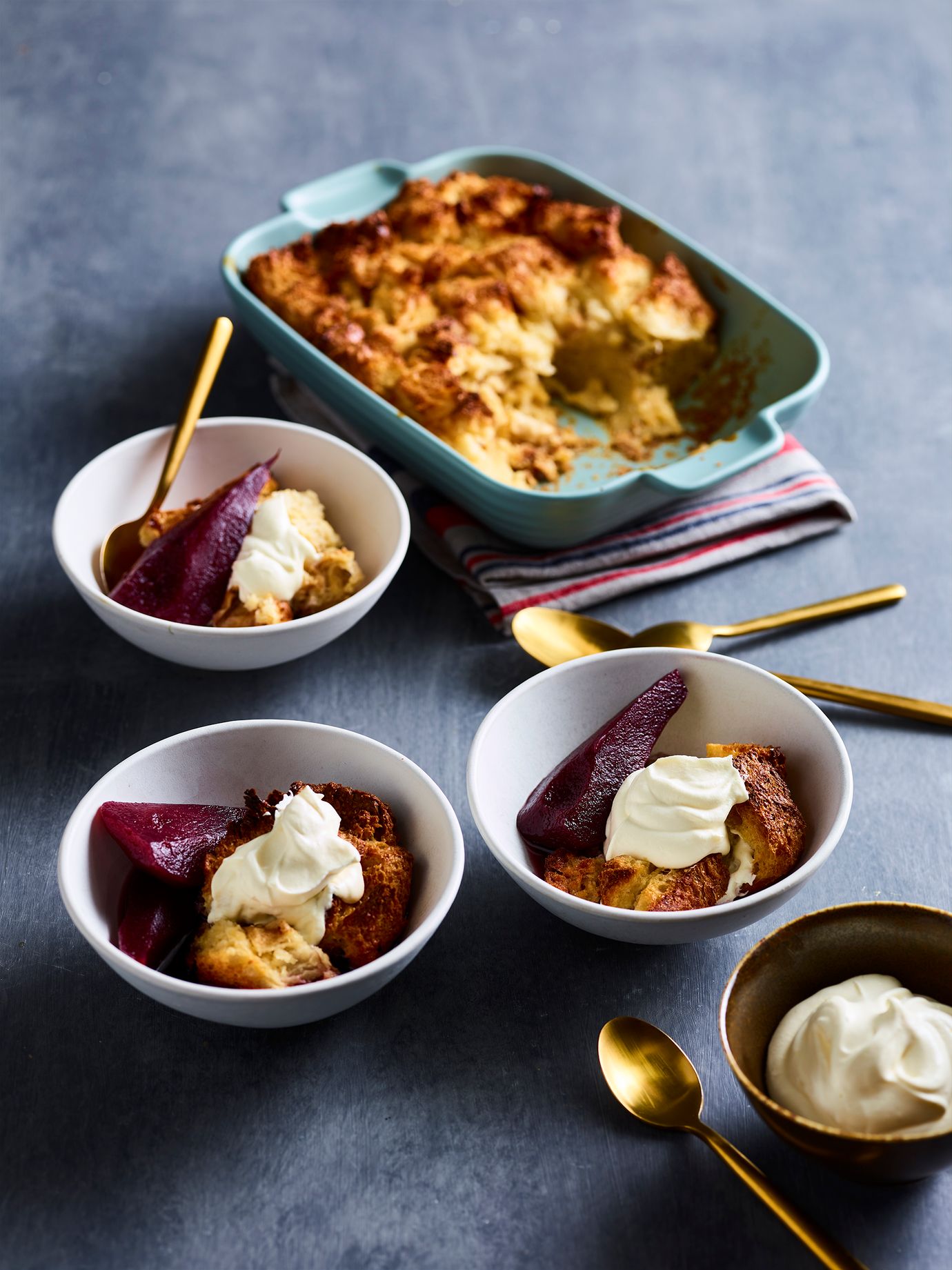 Bread and butter pudding with poached winter fruit and tangy cream