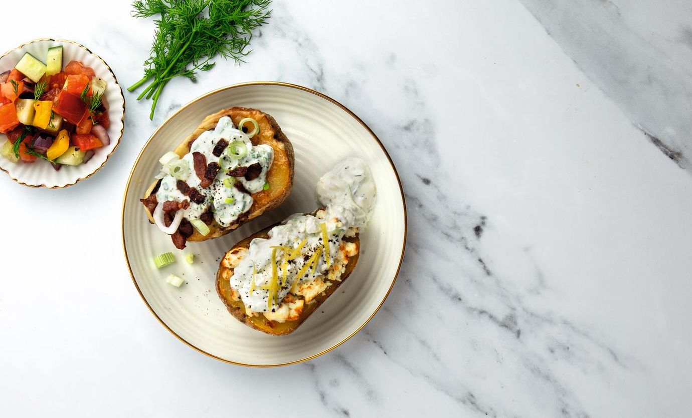 Baked potatoes with cheese, spring onions and bacon