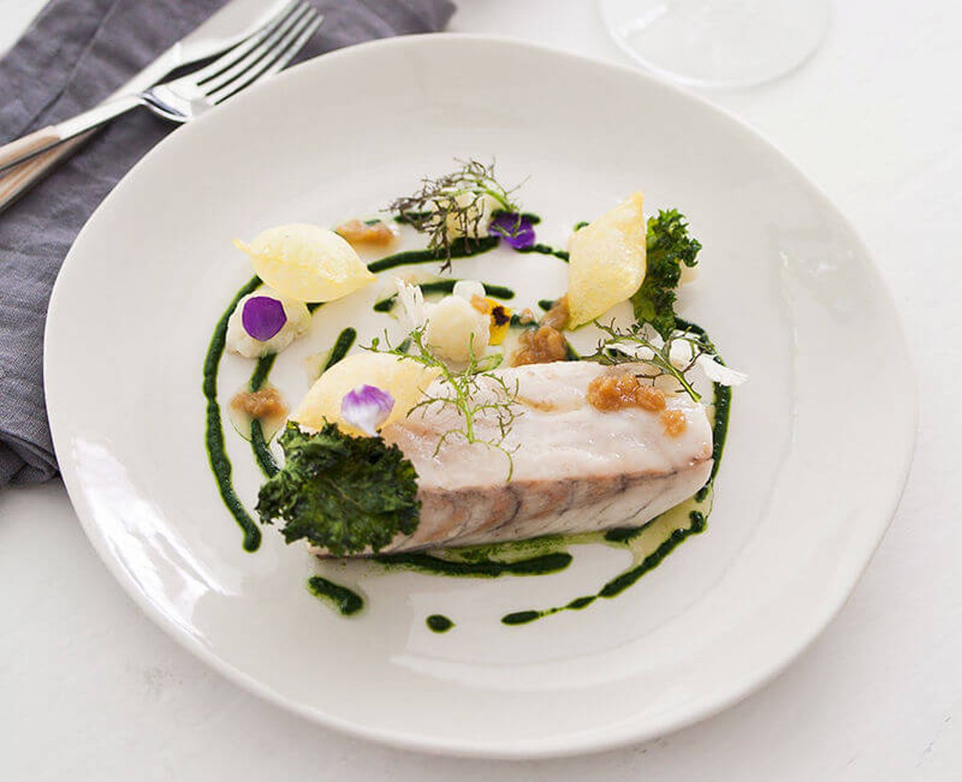 Barramundi with pommes souffle and young garlic sauce