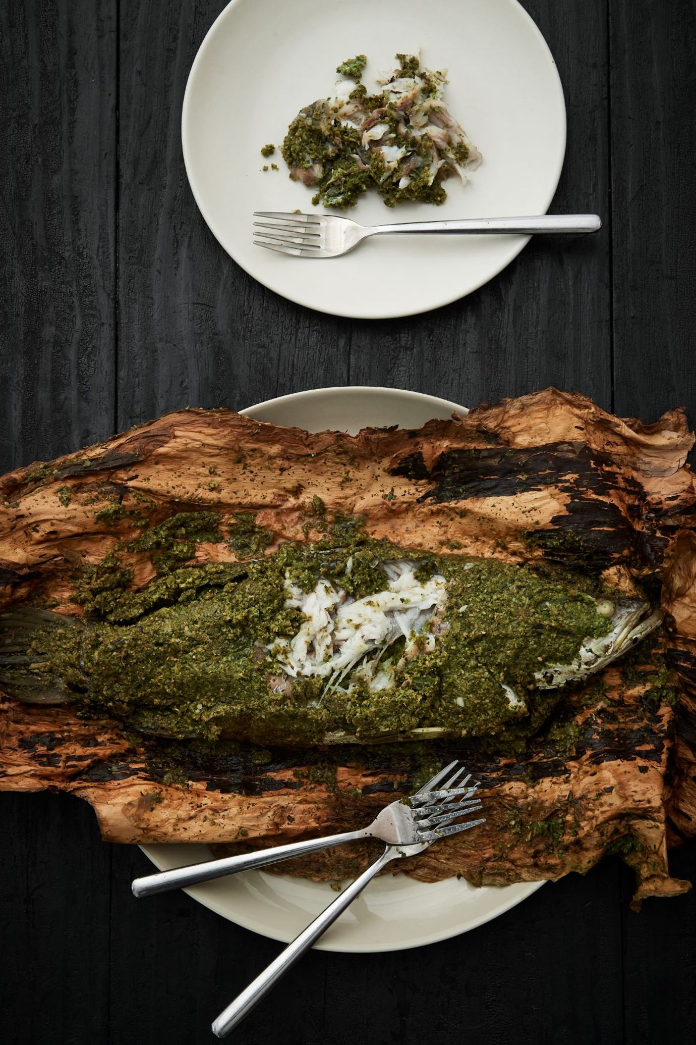 Barramundi cooked in paper bark with green ant gin