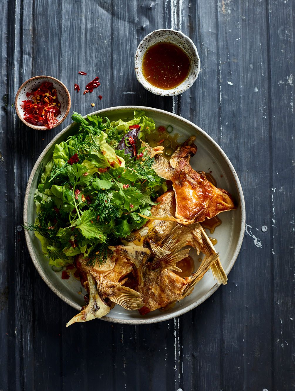 Fried fish collars with palm sugar and tamarind caramel and soft herb salad
