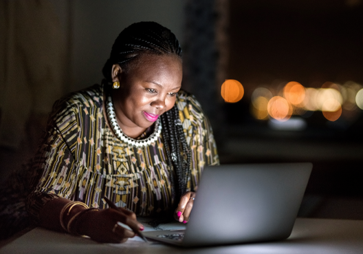 Debt consolidation woman sitting at her desk making notes