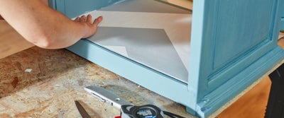 49.Applying_wallpaper_to_cupboard.jpeg
