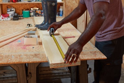 Measuring wood with a tape