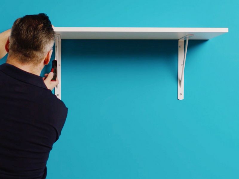 Man putting up a shelf