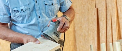 25._Sanding_frayed_timberboard_edges_with_palm_sander.jpg