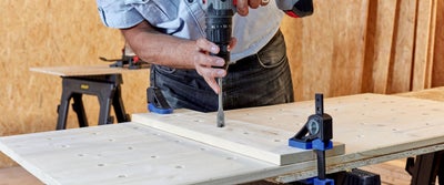 16._Drilling_holes_into_timberboard_through_jig_holes.jpg