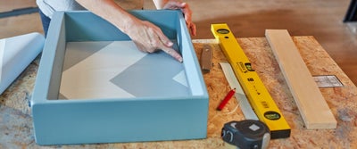 50.Applying_wallpaper_to_cupboard.jpeg
