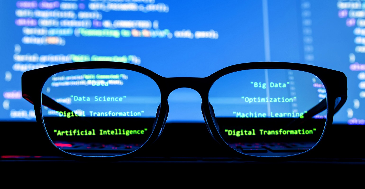 Silhouette glasses in front of laptop computer screen