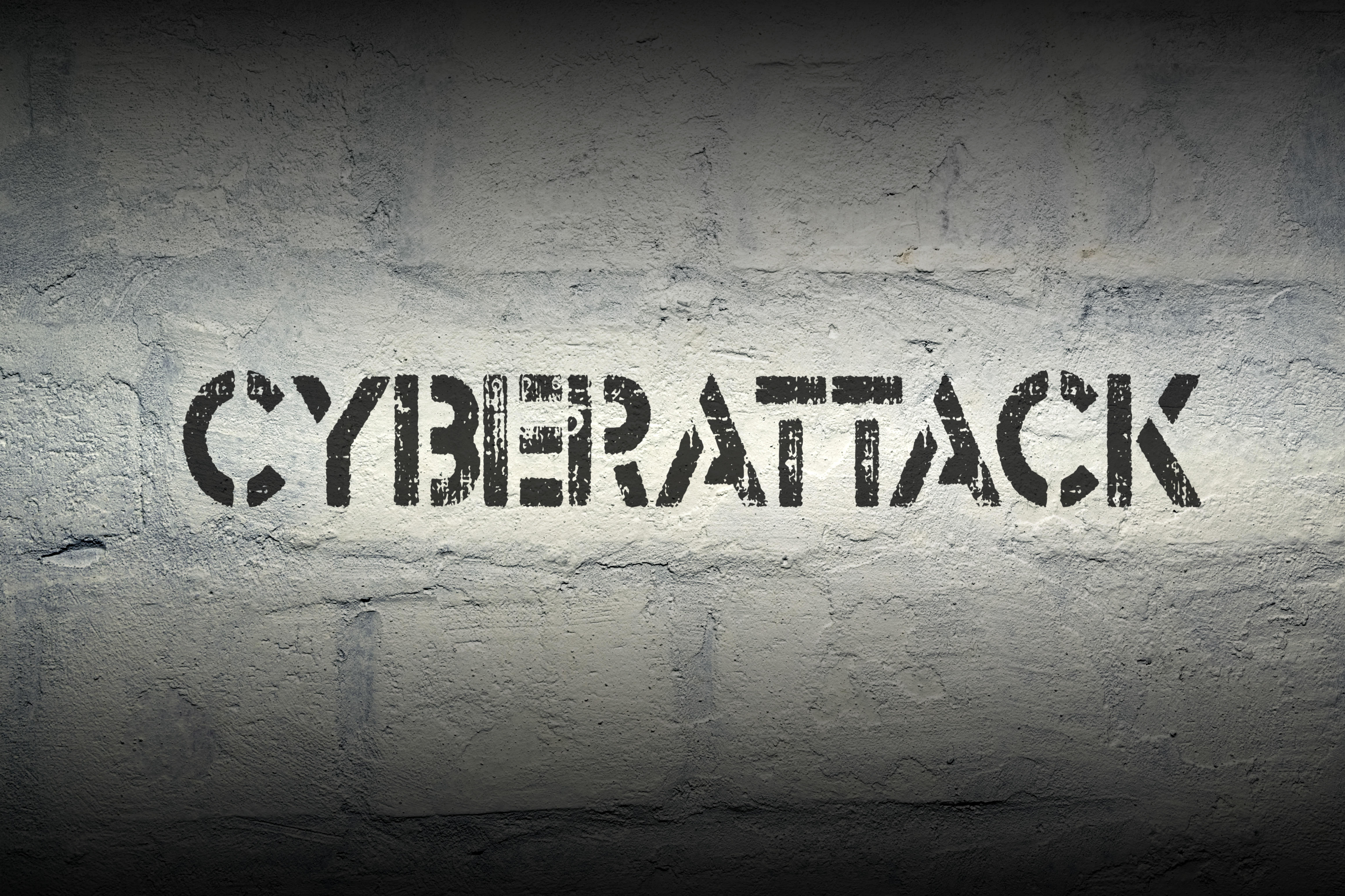 the word cyberattack written on a wall