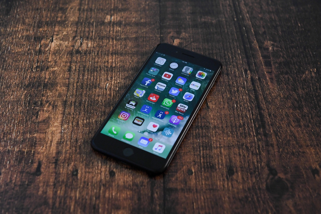 Apple iPhone on a wooden surface Apple iPhone on a wooden surface