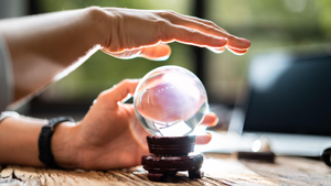 hand hovering over a crystal ball hand hovering over a crystal ball