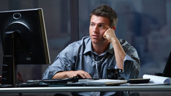 man looking at computer monitor man looking at computer monitor