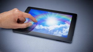 hand with pointer finger touching screen of digital tablet
