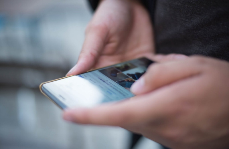 Person holding phone Person holding phone