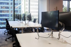 workstations in an office with no employees present workstations in an office with no employees present