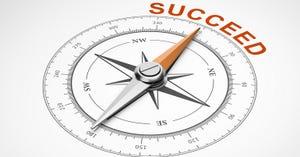 compass with its arrow pointing to the word SUCCEED