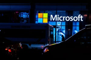 illuminated Microsoft logo in a dark area