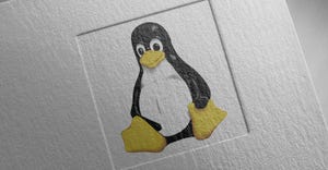 Linux Tux penguin logo on paper