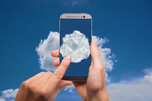 Hands holding a smartphone with images of clouds