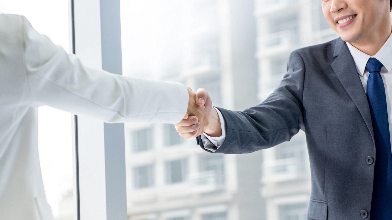 two business people shaking hands two business people shaking hands