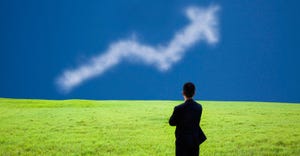 businessman standing in a field looking at a cloud shaped like an arrow businessman standing in a field looking at a cloud shaped like an arrow