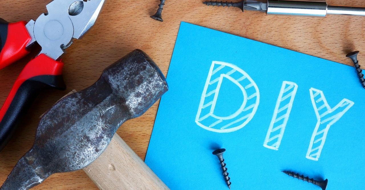 DIY on blue paper surrounded by tools DIY on blue paper surrounded by tools