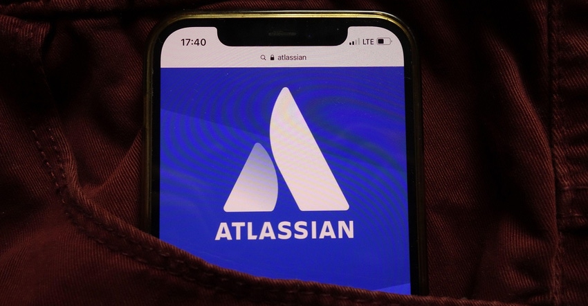 smartphone in pocket with Atlassian logo on its screen
