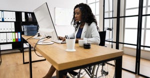 employee in wheelchair working on a laptop employee in wheelchair working on a laptop