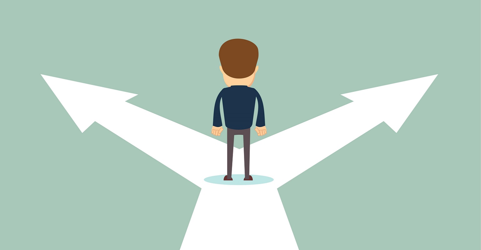 man standing at a fork in the road