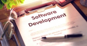 paper with words "software development" on a clipboard