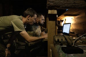 Ukrainian soldiers work in a drone unit command center near Bakhmut