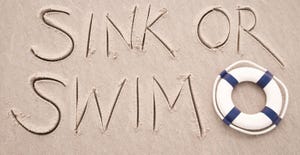 "sink or swim" written in the sand "sink or swim" written in the sand